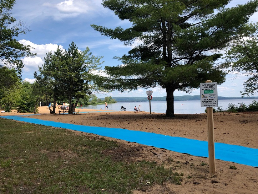 Blue beach mat across sand