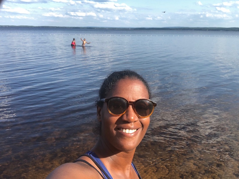 Photo of woman in front of lake