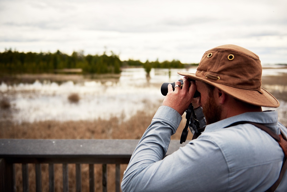 Guy looking with binoculars