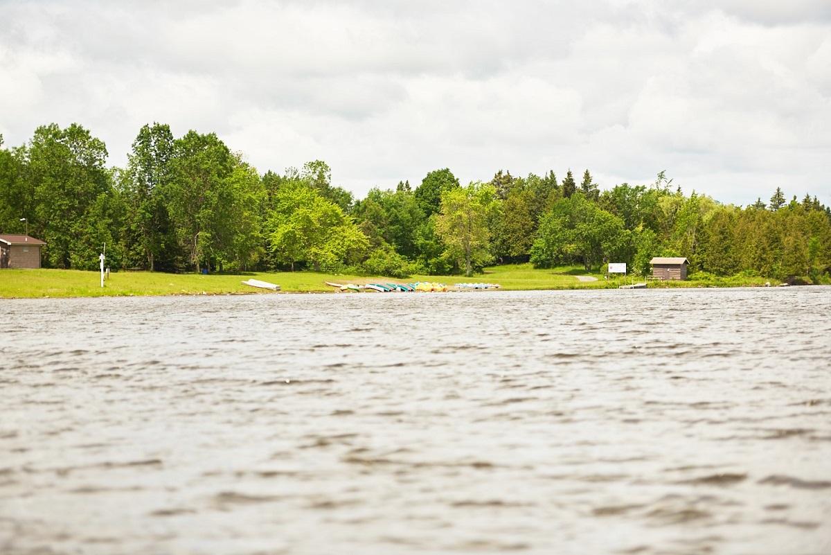 Shoreline with canoe rentals offered in the distance