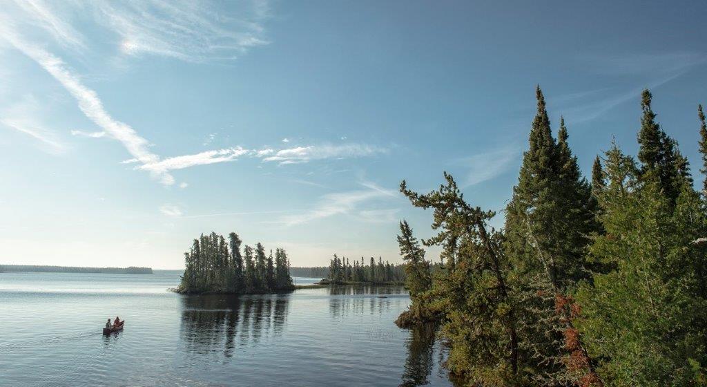 Lakescape with canoe floating with two paddlers 