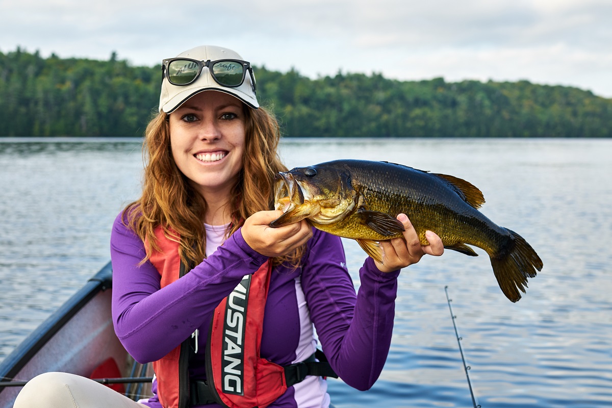 Woman holding up a largemouth bass