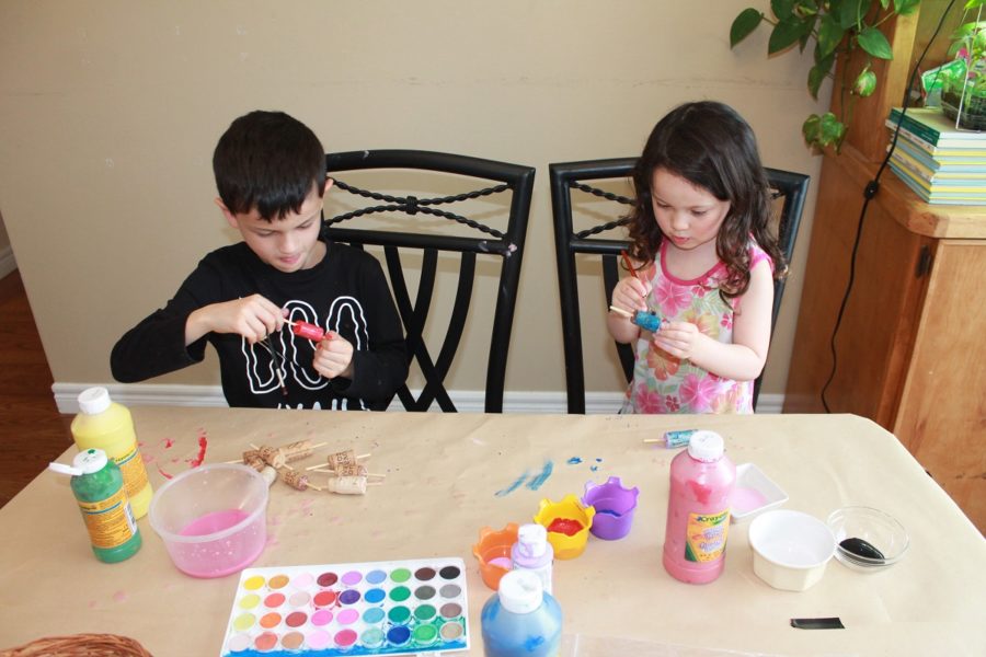 Two kids at a table making bobbers