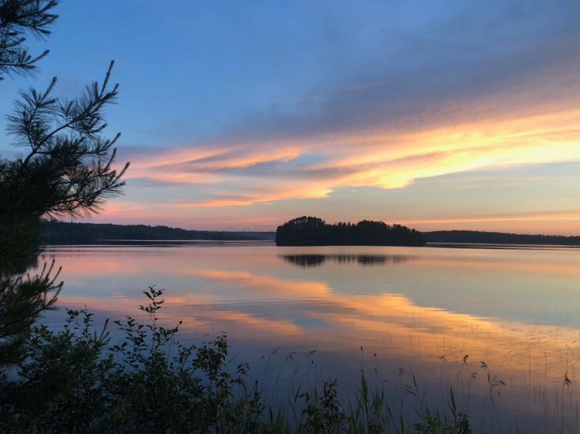 Pink and blue sunset over a lake.