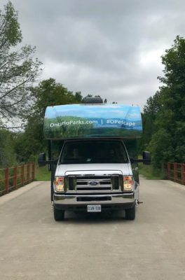 Front view of RV on a gravel road on a cloudy day