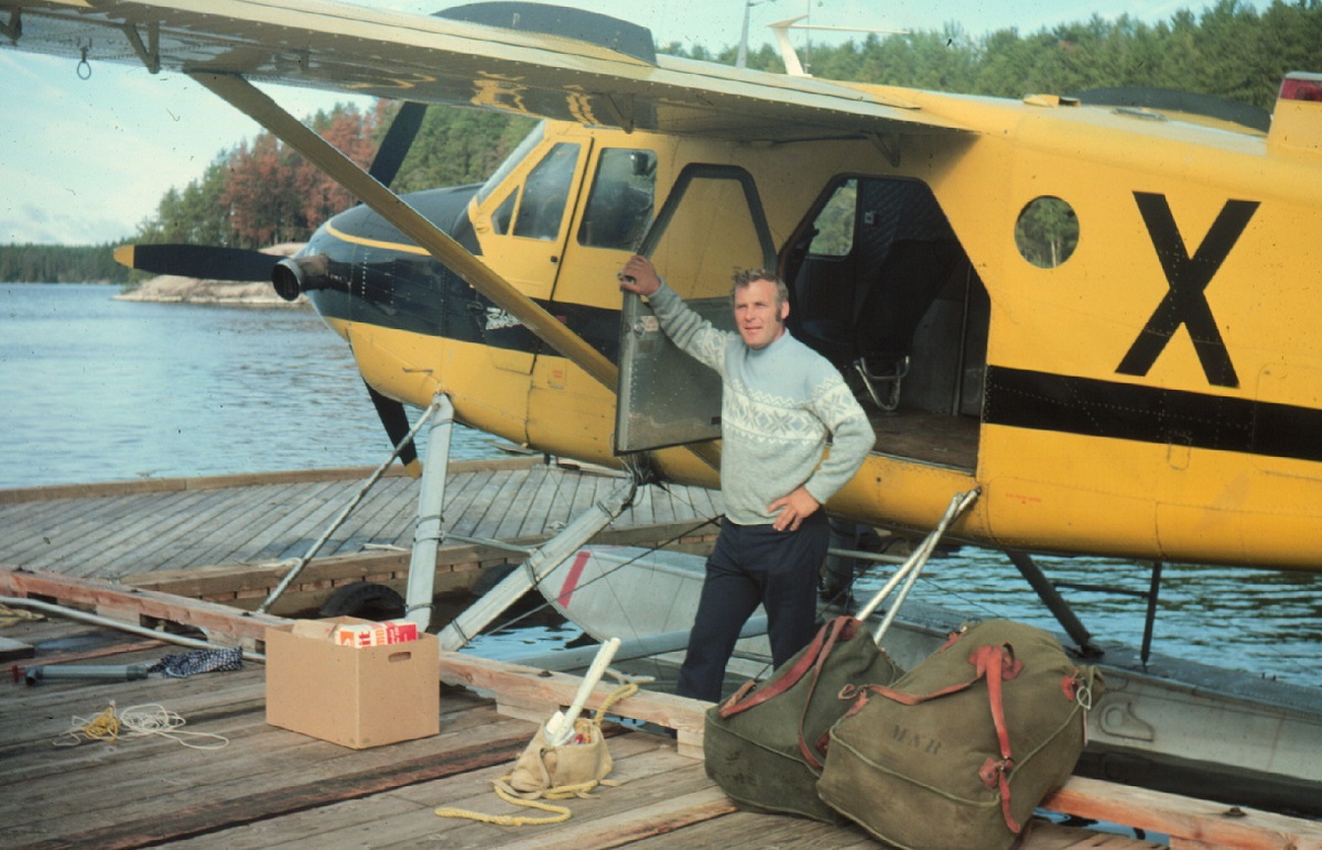 Guy standing in front of yellow bush plane