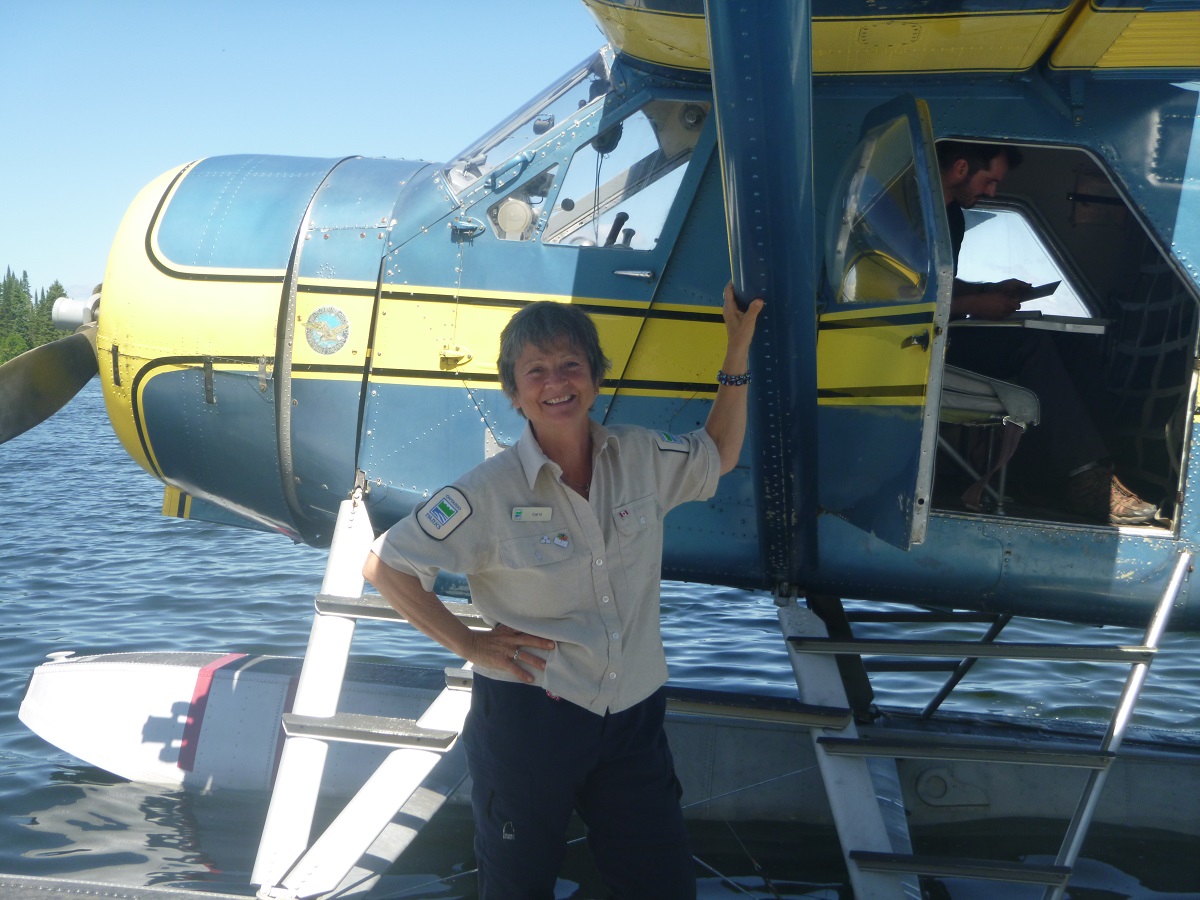 Lady in front of a bush plane