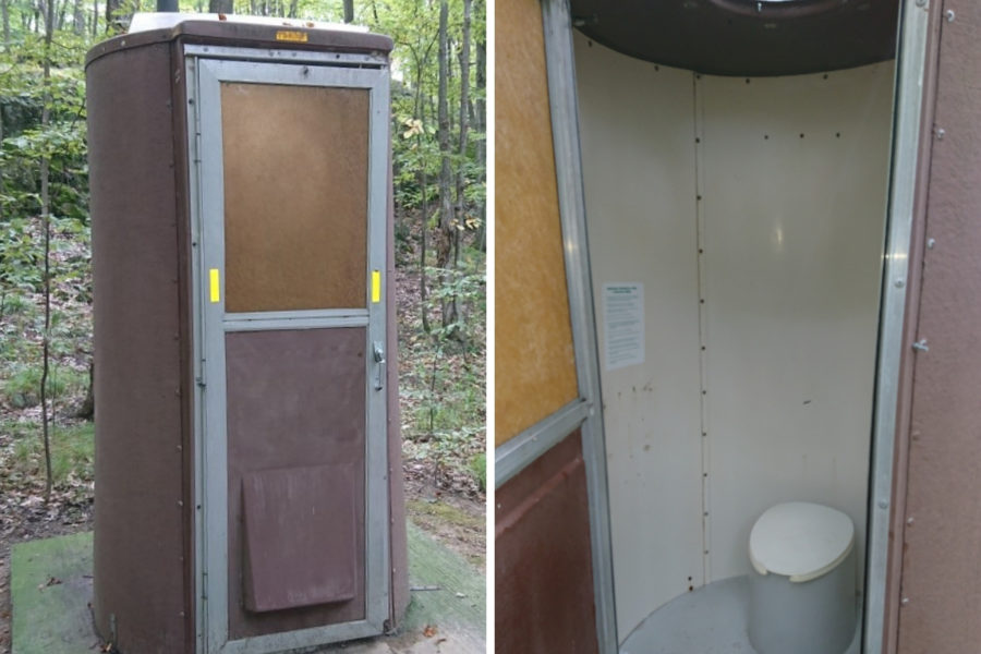 Brown vault outhouse with view of inside