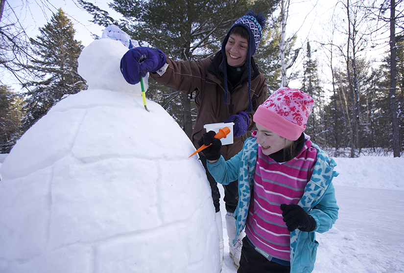 Kids drawing on ice sculpture