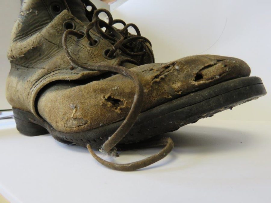 worn down leather boot with holes