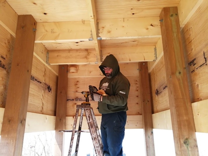 man working on cross beams