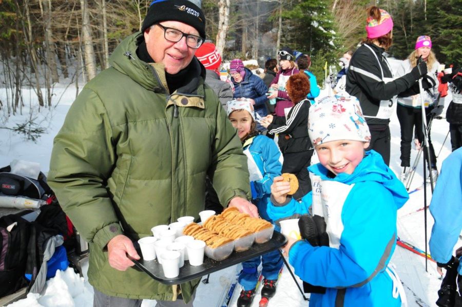 two vilunteers enjoying cookies