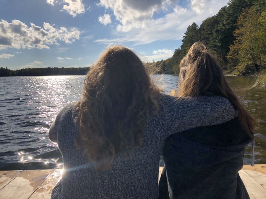 two people sitting on dock 