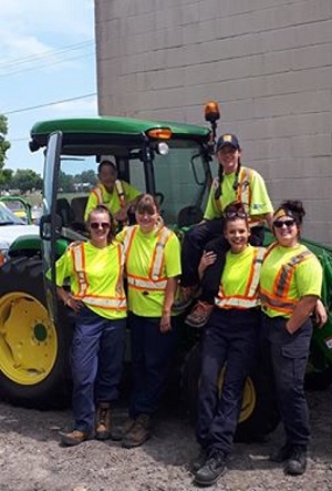 group of staff members posing with machinery