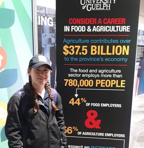 woman in front of agriculture sign