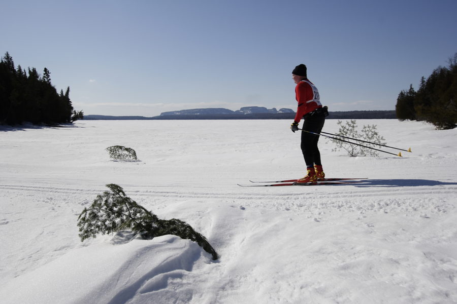 Person skiing at the Loppet along a frozen lake.