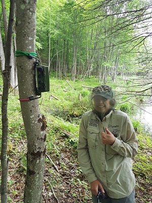 staff member standing near wildlife monitor