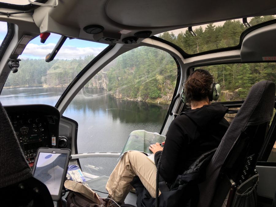 staff member looking out of helicopter