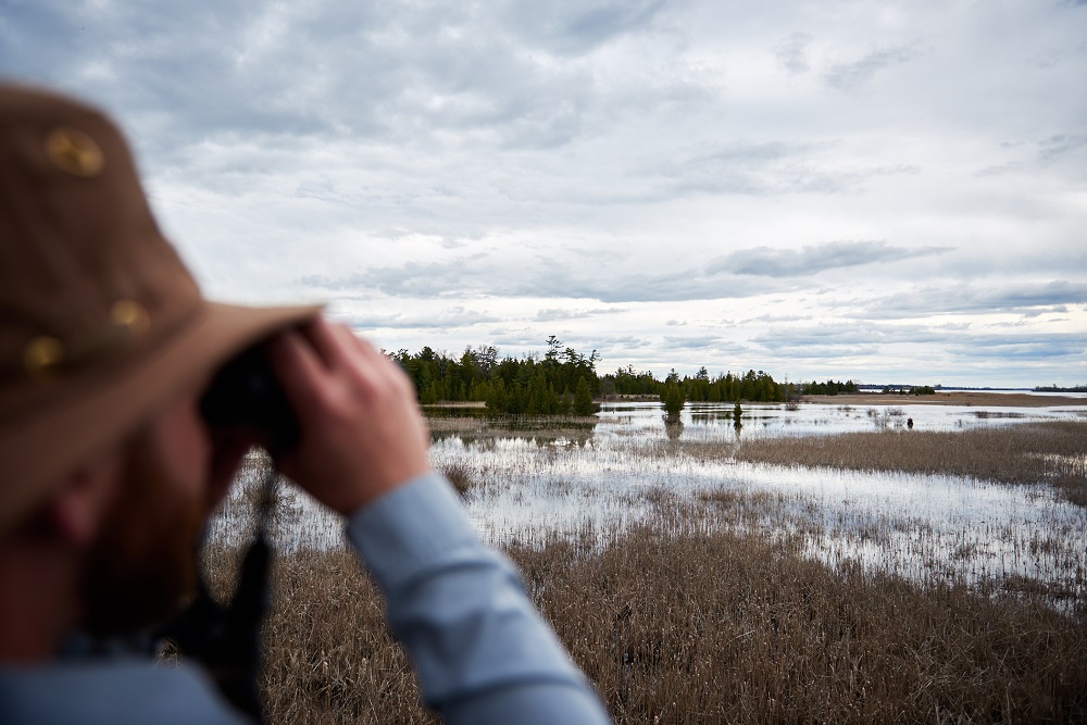 person looking through binoculars