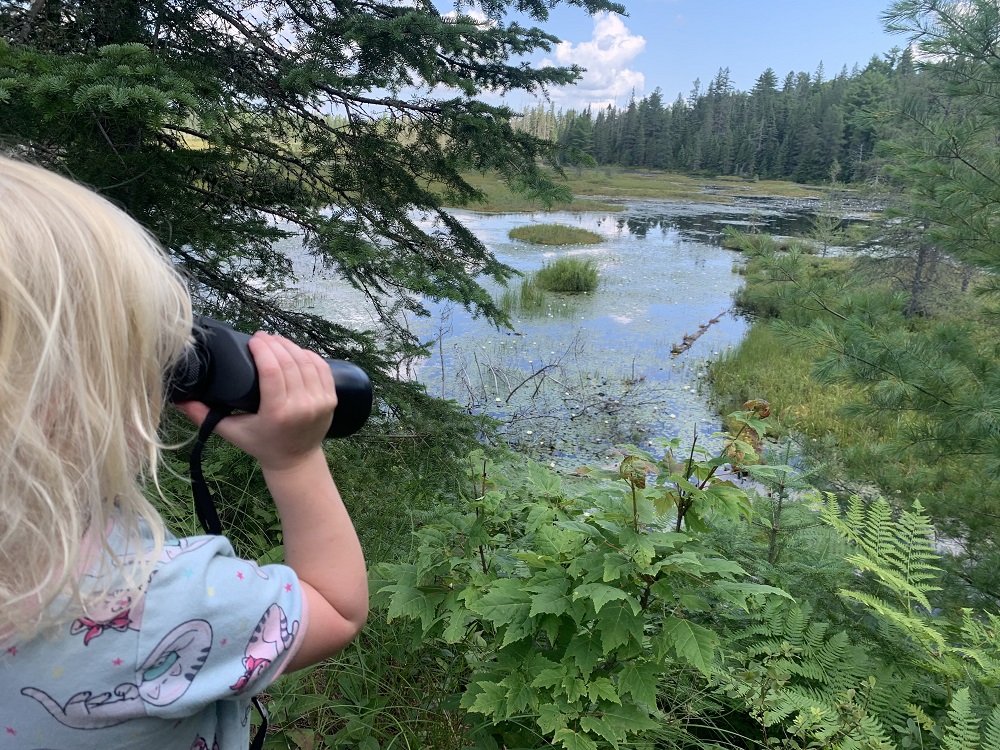 child looking through binoculars