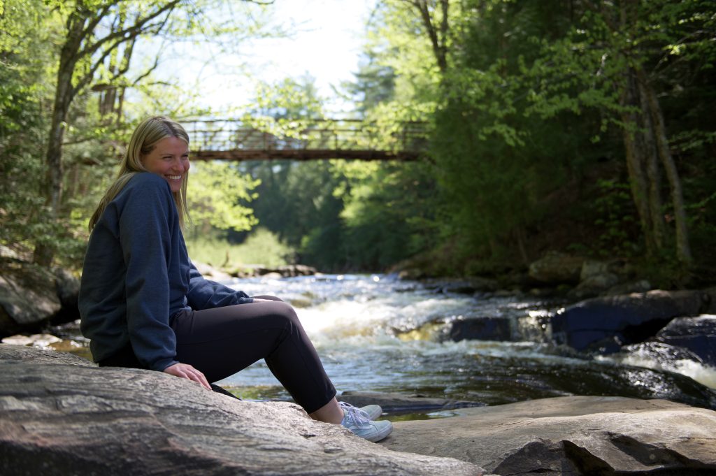 person sitting on rock near Stubb's Falls