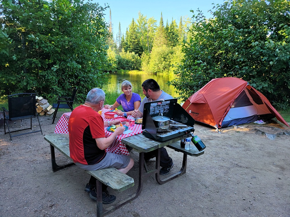 Eating meal on picnic table on campsite