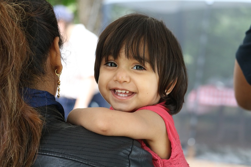 Young child smiles at camera