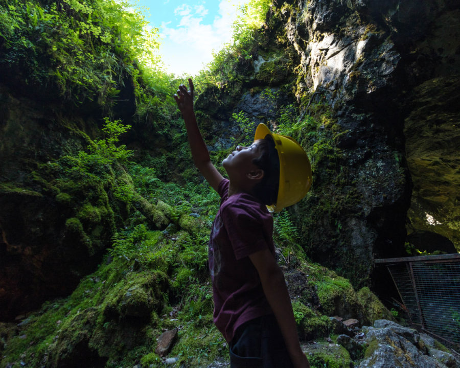 Child looking up through a hole in the mine.