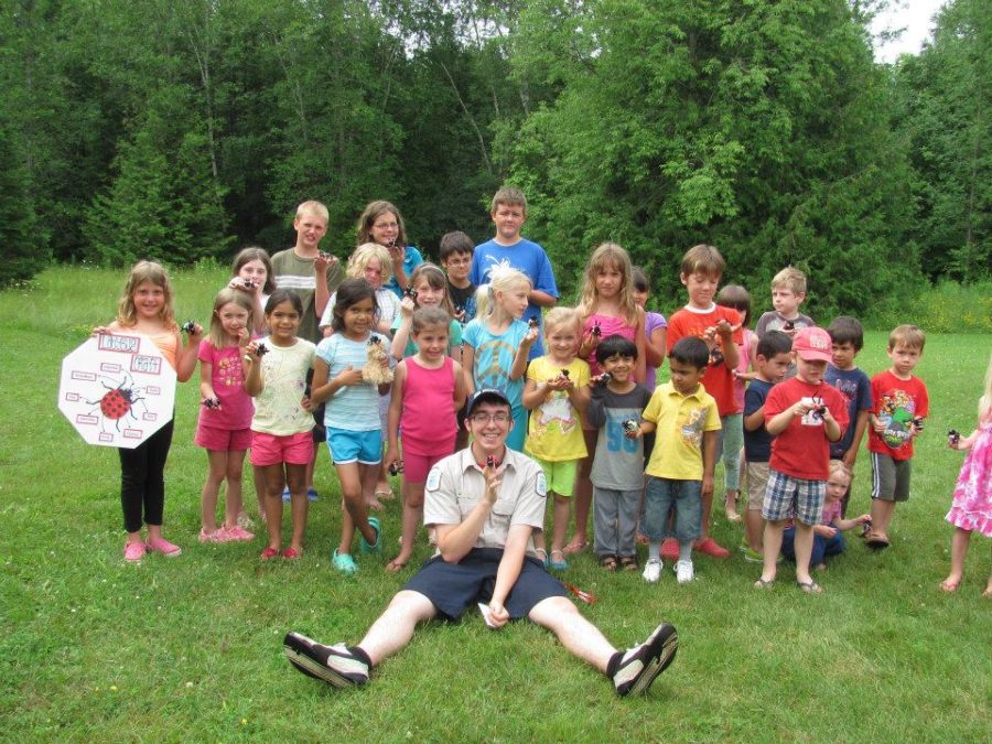 Staff and participants show off ladybug craft they made