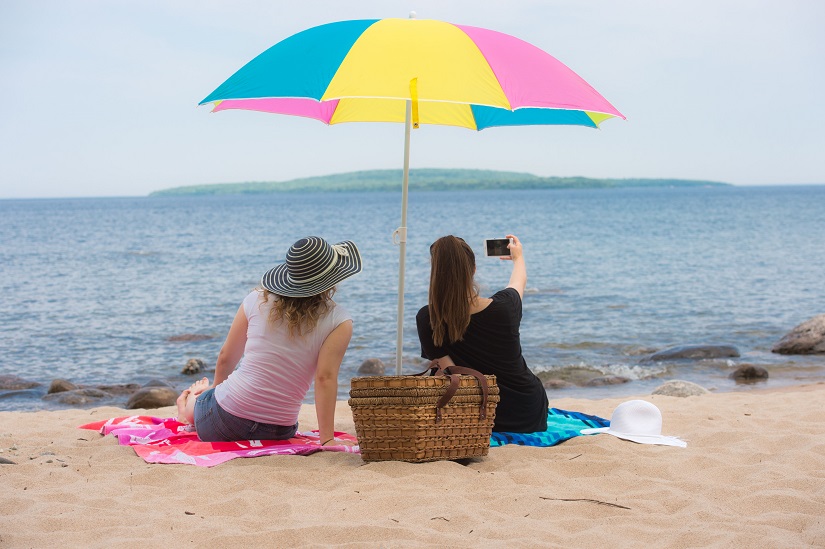 Two people take selfie on beach