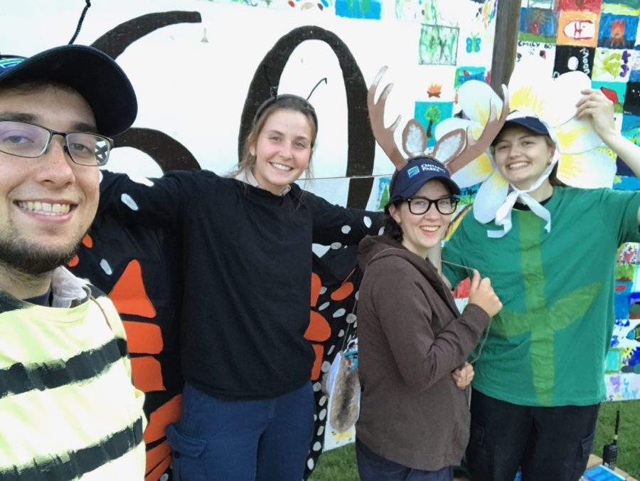 Staff in costumes taking photo after an evening program.