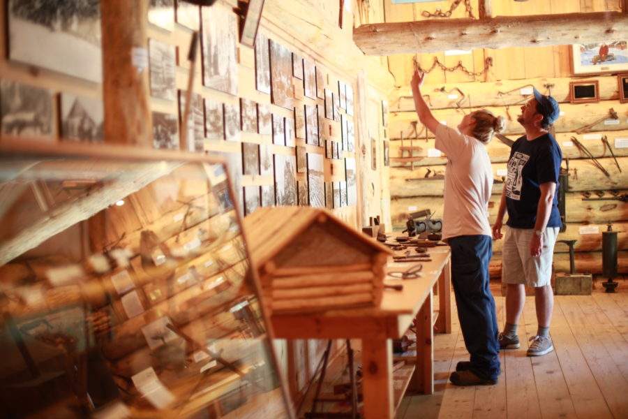 Visitors exploring one of the many logging camp buildings at Marten River