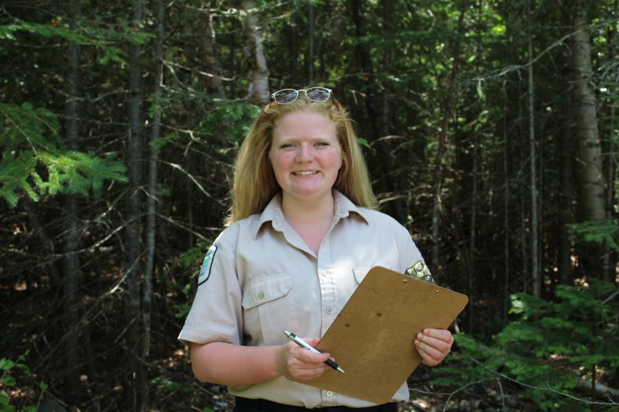 Kathleen holding clipboard in park