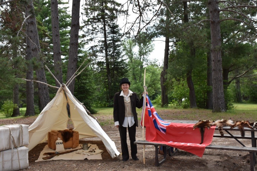 Staff member at a voyageur themed touch table.