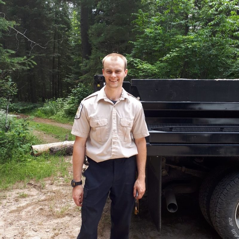 Ranger standing beside truck