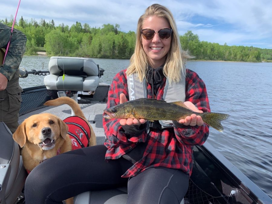 Photo of Pier with a 14" White Lake Walleye as Marley, the dog, looks on. 