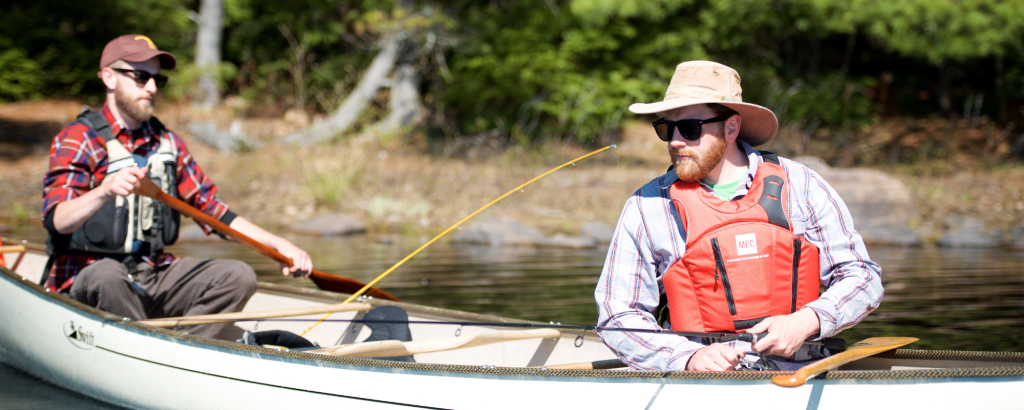 Backcountry campers fishing from canoe