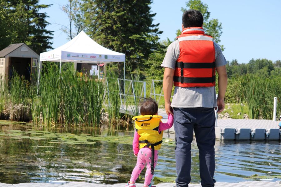 Father and daughter look at water at Learn to Fish session