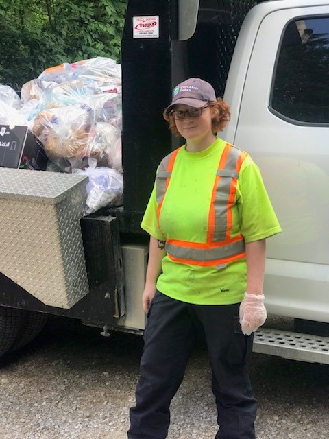 staff in fluorescent shirt in front of truck