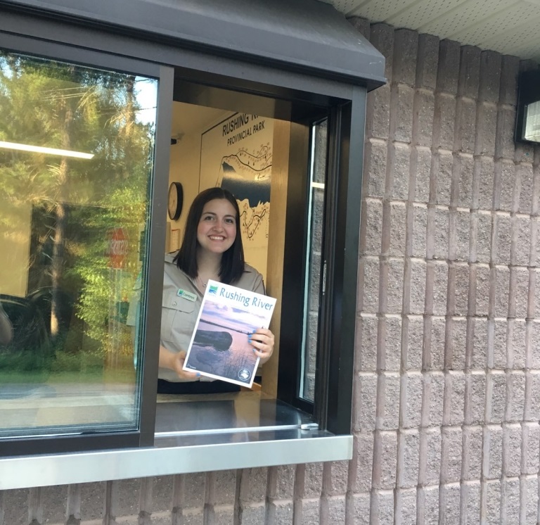 staff holding map in gatehouse window