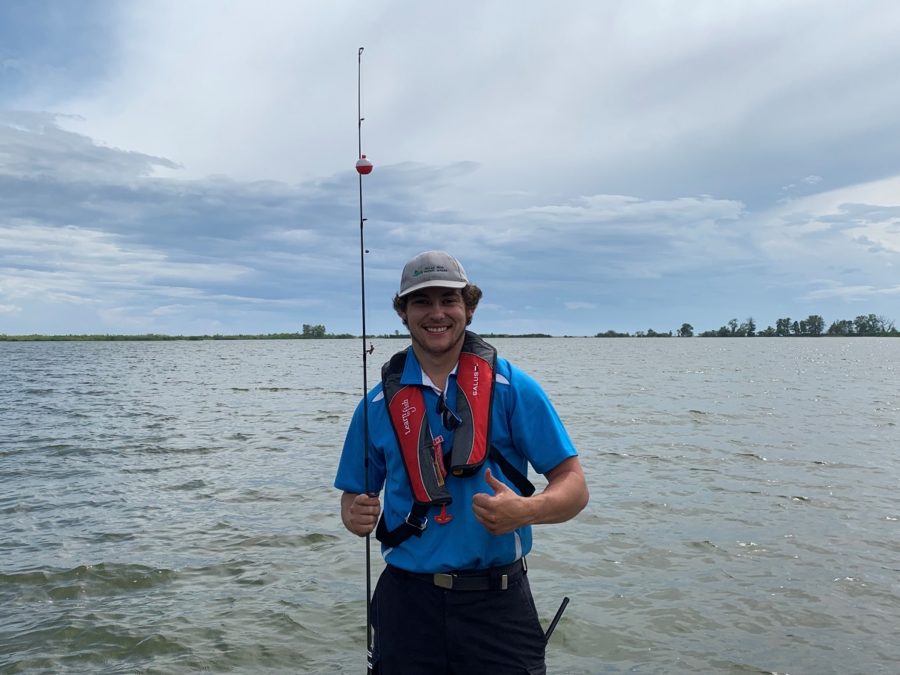 LTF leader holding rod in front of lake