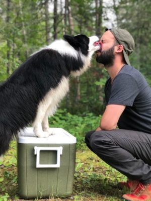 Sitka licking one of her humans face.