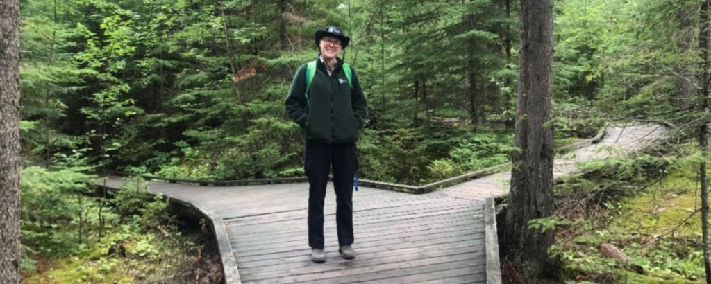 Summer standing on a boardwalk at Blue Lake Provincial Park.