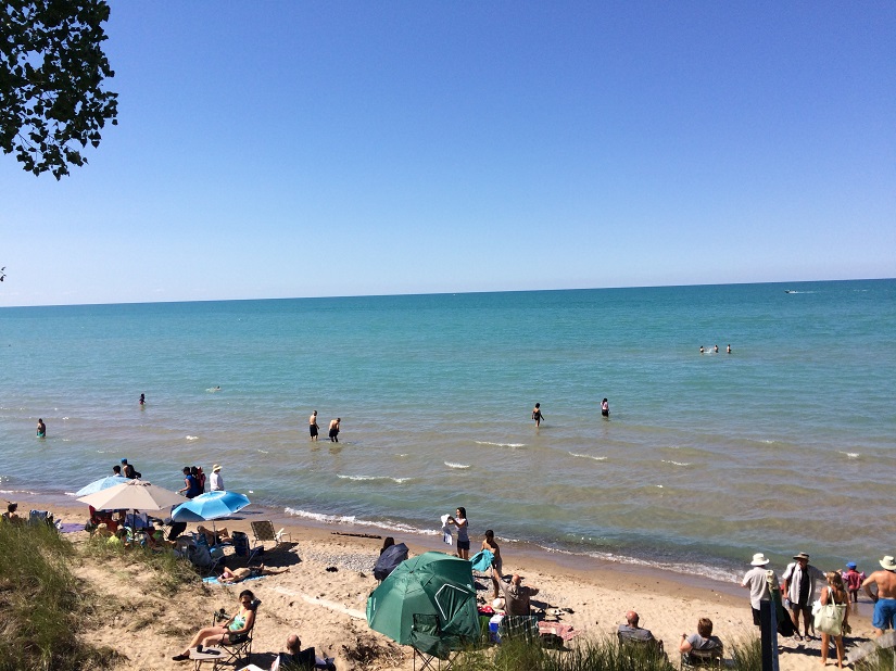 Sandy beach with people enjoying the water