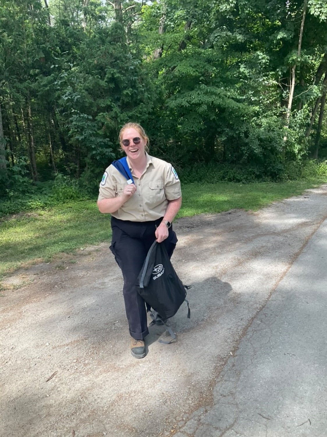 staff holding backpack