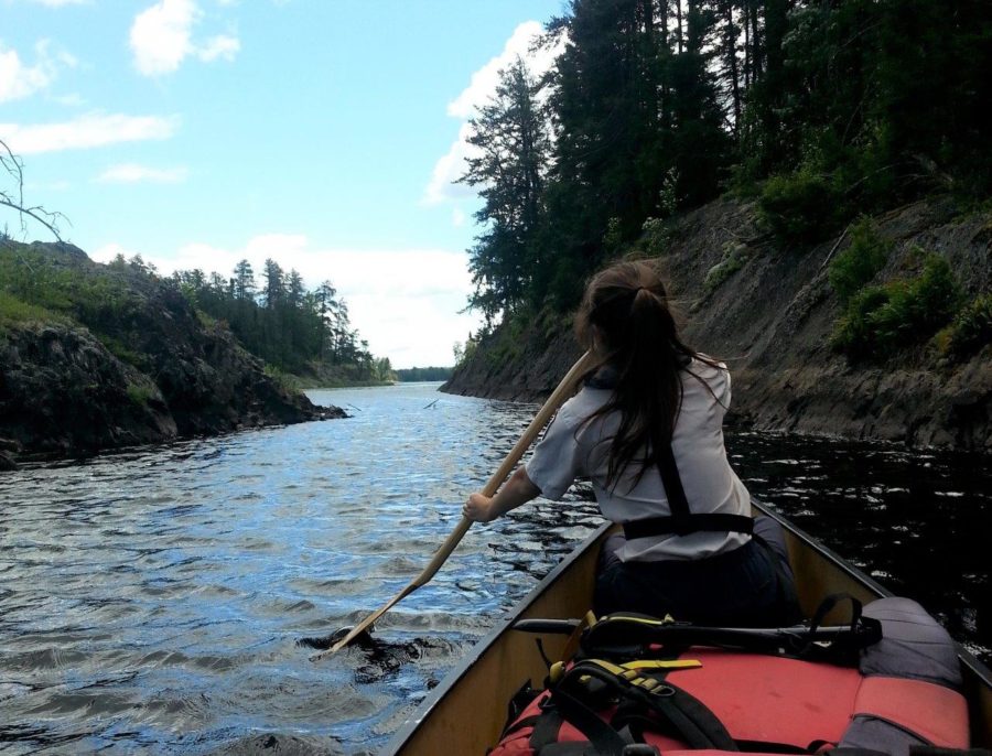 Staff member paddling to the next location.