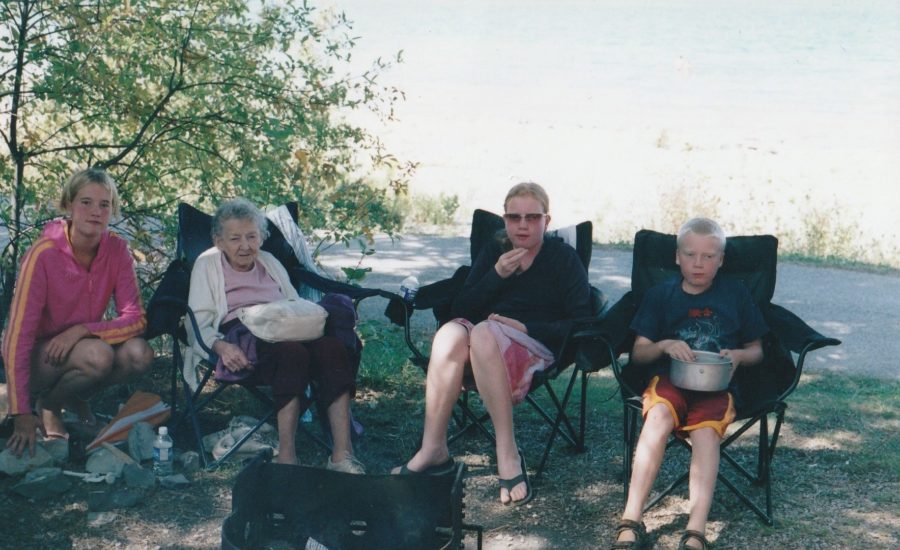 4 campers sitting in lawn chairs