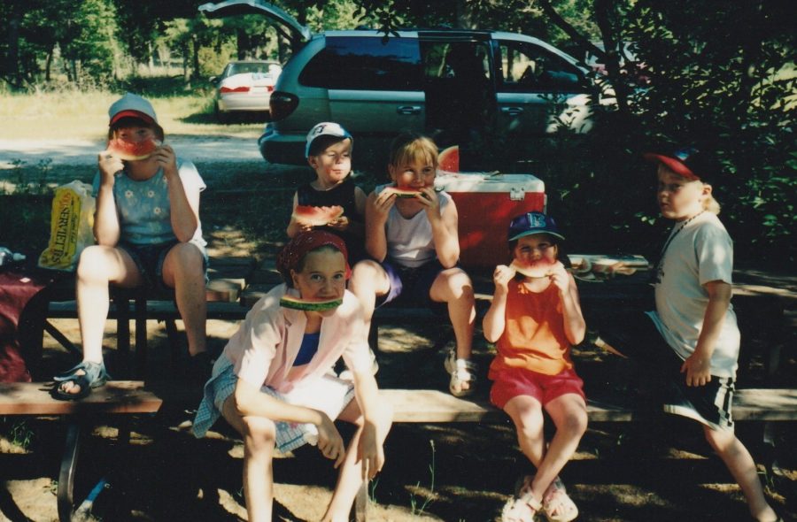 Family photo sitting on a campsite.