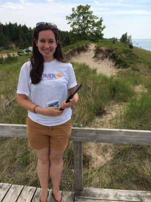 Woman stands on boardwalk by beach