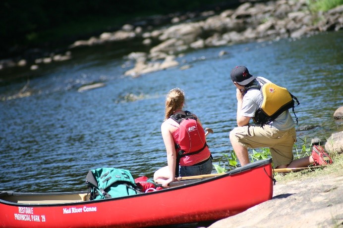 Two paddlers looking out to the rapids.